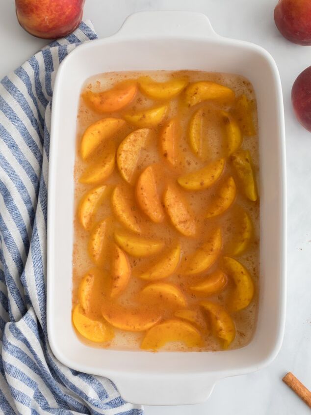 simple 4 ingredient peach dump cake, Laying Peaches in a Baking Dish for Dump Cake Midwest Life and Style Blog