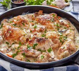 the best texas chicken portobello mushroom recipe, hot chicken in a black dutch oven on a black table chicken meat browned and stewed in white wine cream sauce with mushrooms and vegetables