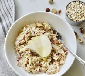authentic bircher muesli the original overnight oats, bowl of Bircher muesli with hazelnuts and oats on kitchen counter with towel