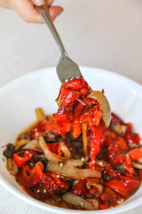 gluten free roasted peppers and onions recipe, roasted peppers and onions in a bowl being picked up with a fork