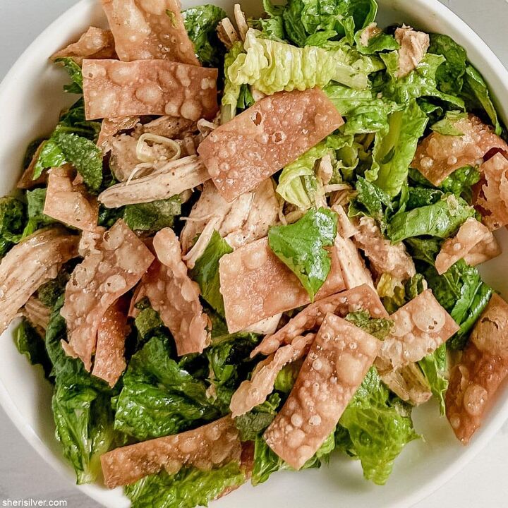 make this easy crispy wonton chicken salad recipe, crispy wonton chicken salad in a white ceramic bowl