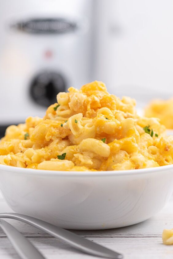 awesome slow cooker macaroni cheese with just 5 ingredients, tall bowl of mac and cheese slow cooker pictured in background