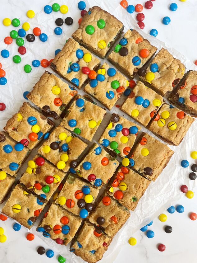 chewy m m cookie bars only 6 ingredients, Chewy M M Cookie Bars cut up on parchment paper with M M s all around