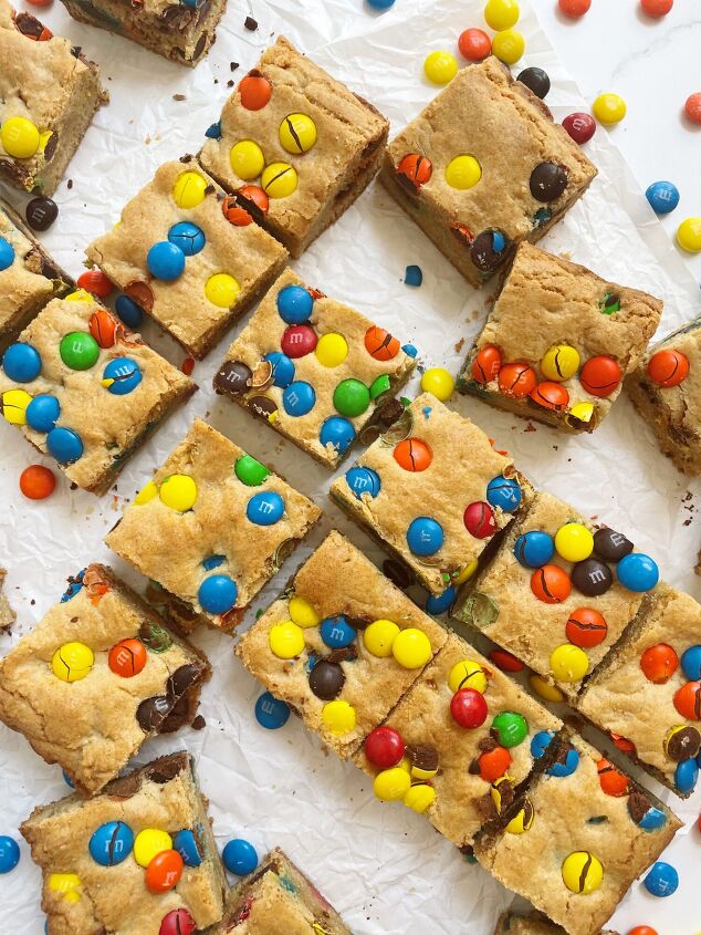 chewy m m cookie bars only 6 ingredients, Cut up chewy M M cookie bars scattered on parchment paper