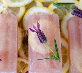 lavender gin lemonade popsicles, Three Lavender Gin Lemonade Popsicles in a row laying on a bed of fresh lemon slices