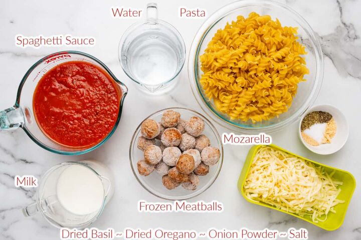 meatball casserole, Ingredients on a table labeled that include spaghetti sauce water pasta milk frozen meatballs mozzarella cheese and seasonings