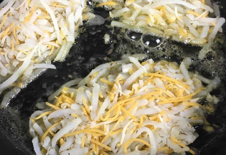 easy cheesy hash brown recipe, Cheesy hash browns cooking in skillet Photo Credit An Off Grid Life