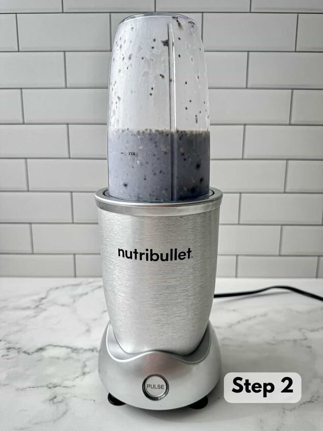 blueberry protein shake, A blue liquid with blueberries almond milk chia seeds and Brazil nuts in a Nutribullet blender
