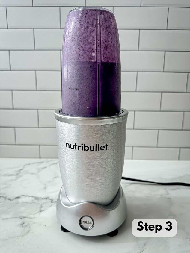 blueberry protein shake, A purple liquid blended together in a blender cup