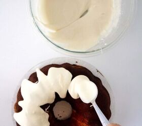 red velvet bundt cake with cream cheese, A person is putting frosting on a bundt cake