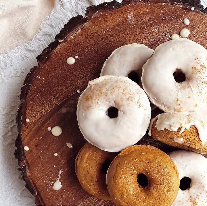sweet potato cake with marshmallow meringue, top down view of baked pumpkin donuts on a round wooden charger donuts are topped with a coffee flavored glaze and sprinkled with cinnamon