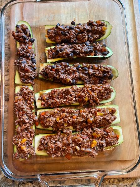 easy zucchini boats 2 ways, Italian and Mexican stuffed Zucchini Boats in a glass baking dish prior to baking