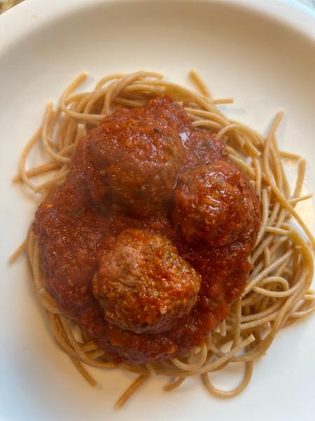 easy and delicious meatballs, Spaghetti and meatballs on a white plate with no garnish