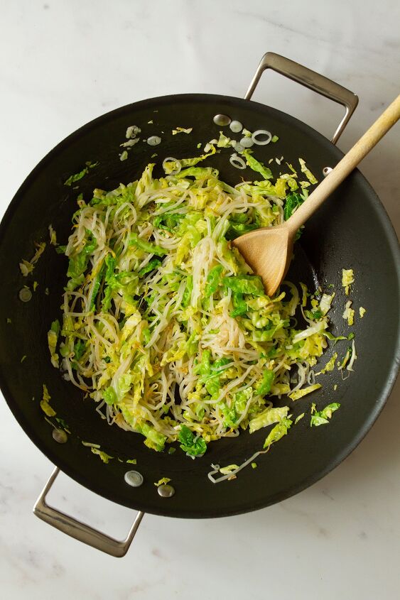 plain chow mein noodles beansprout chowmein, Stirring the fried cabbage scallions bean sprouts and garlic in a dark coloured wok using a wooden spoon