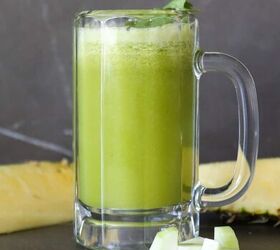 pineapple and cucumber detox juice recipe, Cucumber and pineapple juice in a glass with sliced cucumber and cilantro garnish