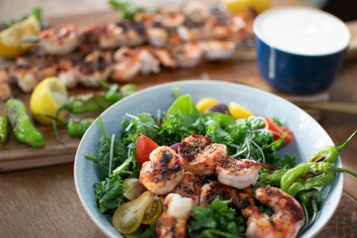 grilled shrimp caesar salad with blistered shishito peppers