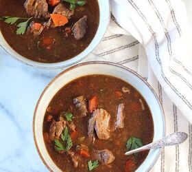 korean beef stew recipe slow cooker or oven, Two bowls of Korean Beef Stew one with a spoon on counter with blue and white striped towel Korean Beef Stew is sweet salty tangy and oh so flavorful