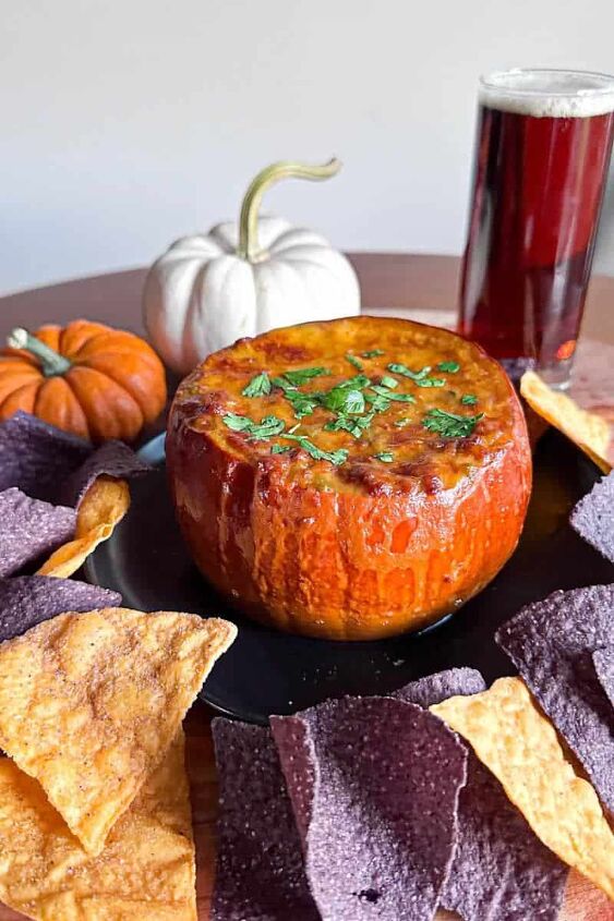 pumpkin queso dip recipe, queso dip in pumpkin surrounded by tortilla chips