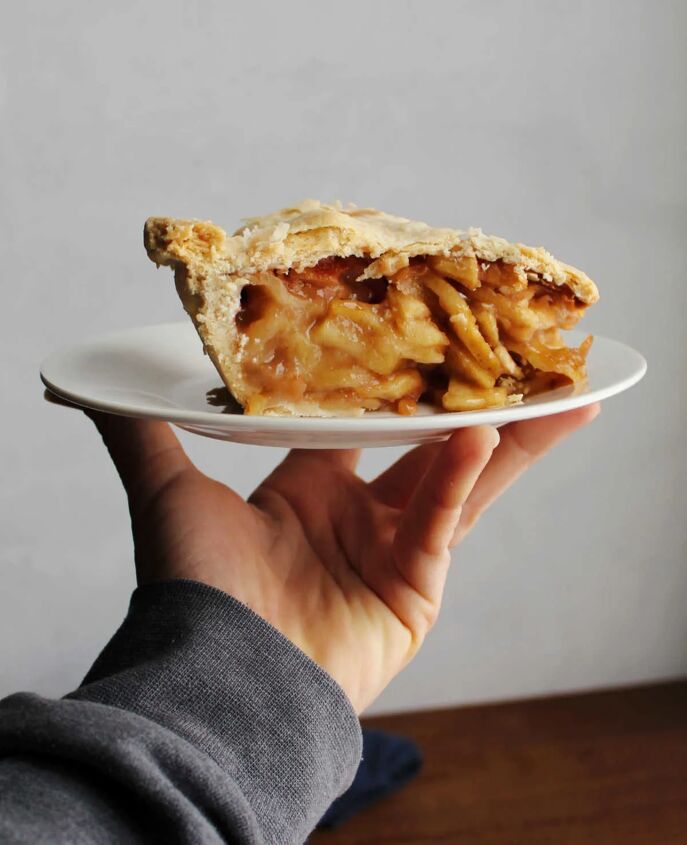 great grandma s apple pie, hand holding plate with slice of apple pie on it