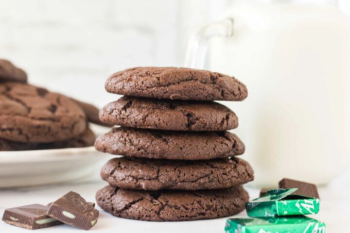 chocolate mint cookies, Stack of chocolate cookies with bits of Andes mints inside next to jug of milk and more chocolate mint candies