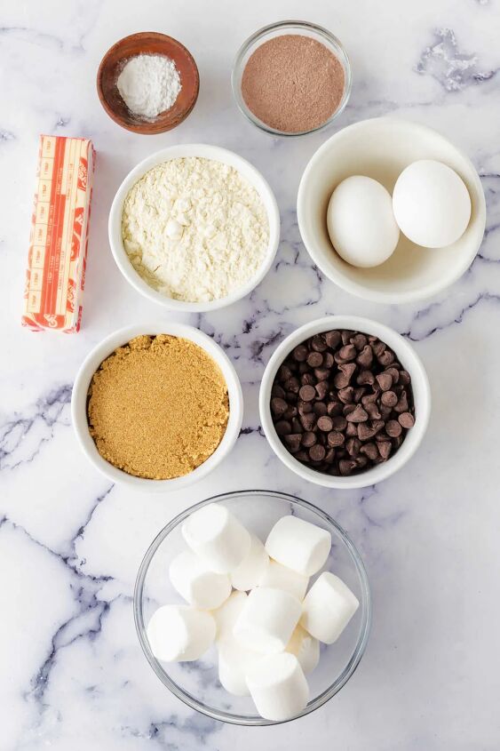 hot chocolate cookies, Ingredients including butter chocolate chips brown sugar flour eggs hot cocoa mix baking powder and marshmallows ready to be made into hot chocolate cookies