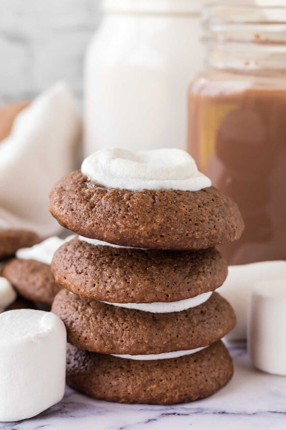 hot chocolate cookies, Hot chocolate cookies stacked on top of each other showing thick chocolate cookie layer and melted marshmallow center