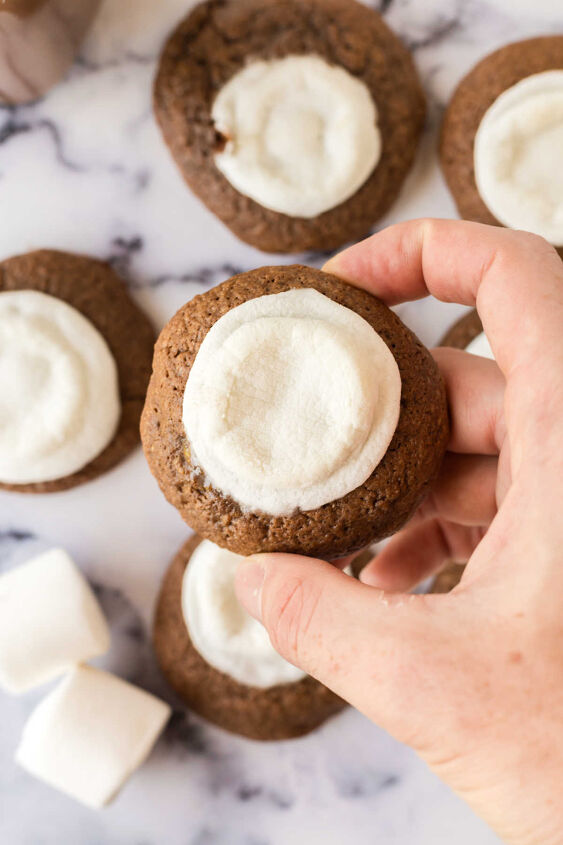 hot chocolate cookies, Hand holding hot cocoa cookie with marshmallow baked on top