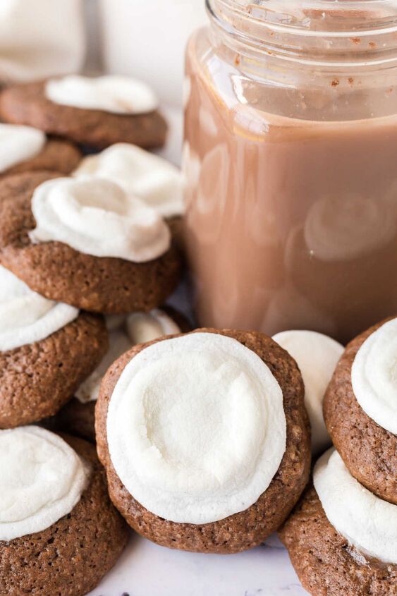 hot chocolate cookies, Large glass of hot chocolate surrounded by hot cocoa cookies with marshmallows melted in the center of each soft chocolate cookie