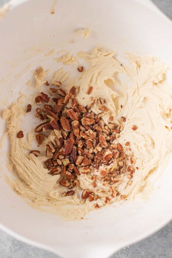 snowball cookie recipe with pecans, cookie dough with chopped pecans in a bowl