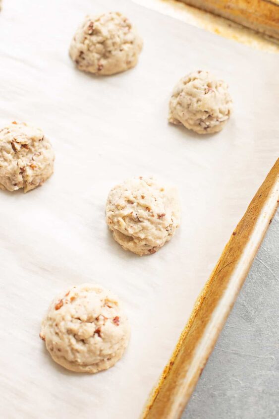snowball cookie recipe with pecans, cookie dough balls on a pan with parchment paper
