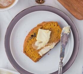 moist pumpkin bread, A piece of pumpkin bread on a white plate with a pat of butter spread on the top with a knife on the side