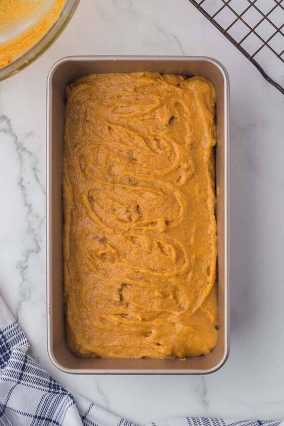 moist pumpkin bread, Uncooked Pumpkin loaf in a baking loaf pan on a marble counter