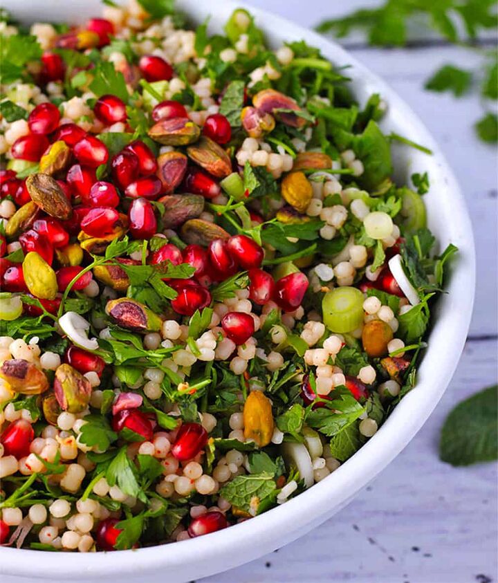 festive pomegranate pearl couscous salad, Pomegranate salad with pearl couscous herbs pistachios and scallions