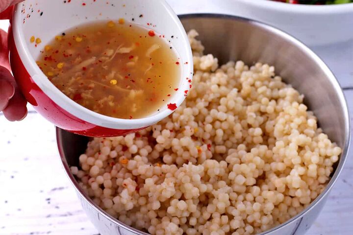 festive pomegranate pearl couscous salad, Lemon juice and chili flakes are poured over pearl couscous
