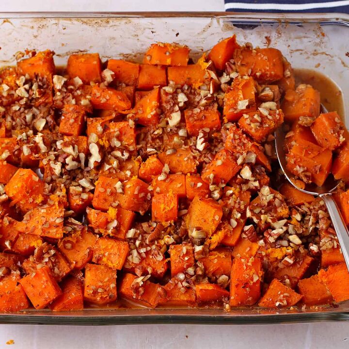 vegan creamed onions recipe, Roasted sweet potatoes with chopped pecans and orange zest in a glass baking dish with a spoon