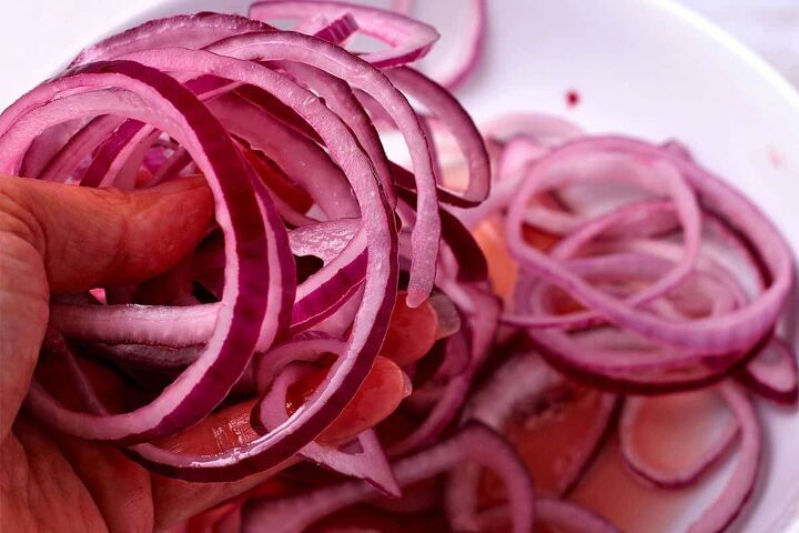 quick pickled red onions no cook recipe, Red onion slices are mixed with pickling marinade