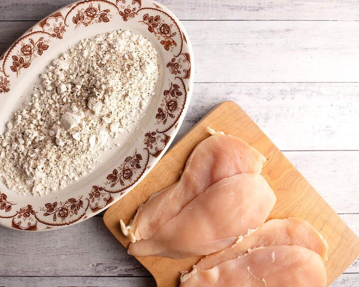 classic chicken marsala, Chicken cut in half horizontally next to a platter of seasoned flour