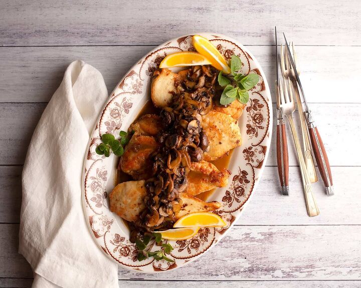 classic chicken marsala, A platter of chicken marsala with oregano and lemon wedges