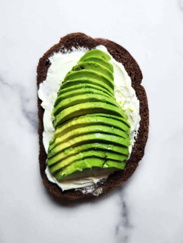 cream cheese avocado toast, Pumpernickel bread with cream cheese and avocado on a white background