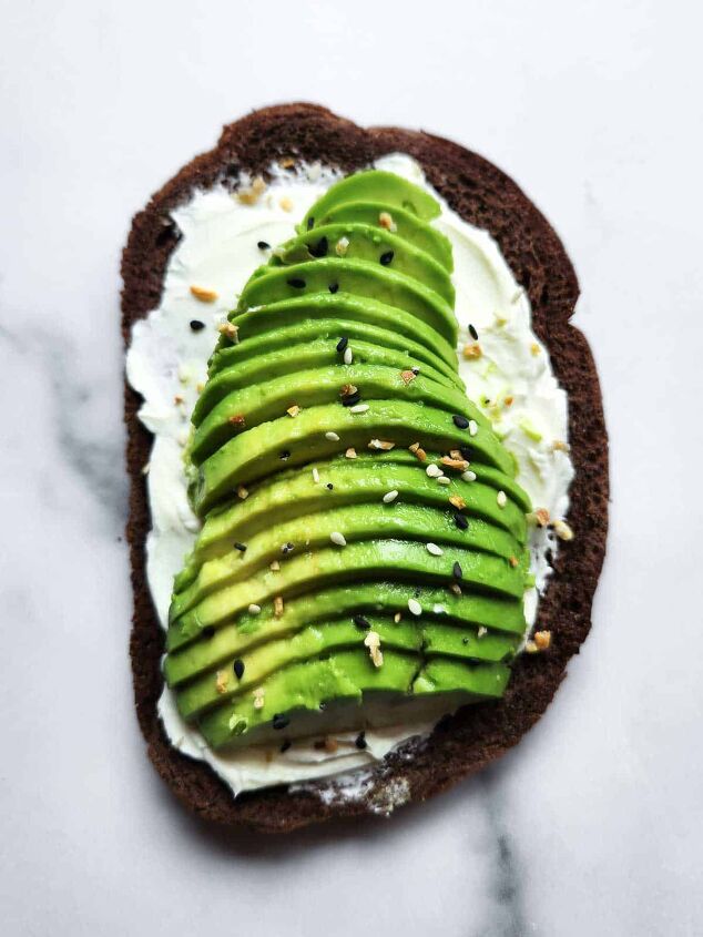 cream cheese avocado toast, Cream cheese and avocado toast with spices on top on a white background