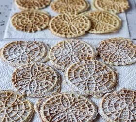 easy lemon pizzelle italian waffle cookies, Cooked lemon pizzelles on paper towels with powdered sugar on them