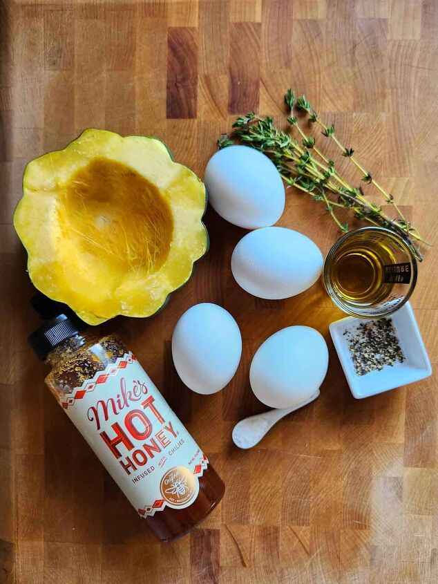 acorn squash egg in a hole with hot honey and thyme, Ingredients for acorn squash egg in a hole on a cutting board
