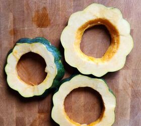 acorn squash egg in a hole with hot honey and thyme, Three acorn squash rings on a cutting board