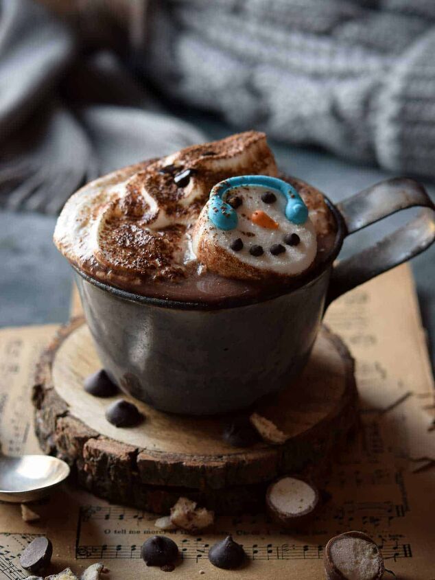 decadent malted milk hot chocolate, Malted milk hot chocolate in a grey mug with whipped cream and snowman marshmallows