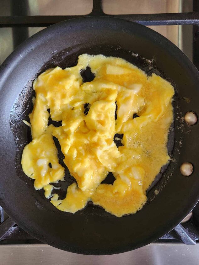 goat cheese scrambled eggs, Semi cooked scrambled eggs in a skillet