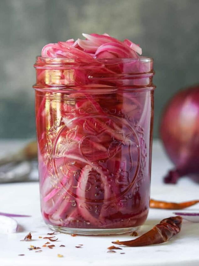 ruby hot chocolate, Close up of a jar of pickled red onions on a white surface