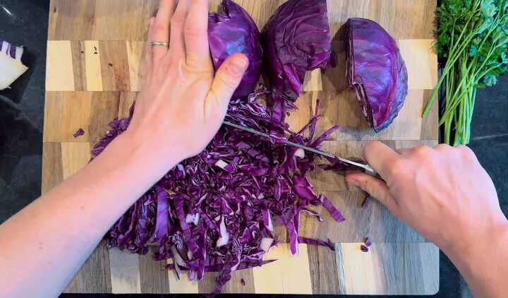 fresh easy turkish red cabbage salad recipe, hands chopping purple cabbage on cutting board