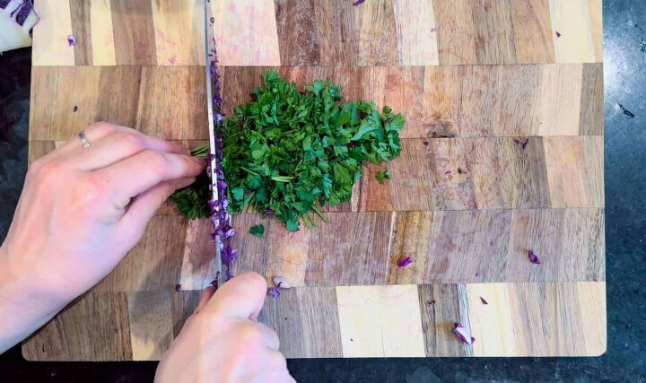 fresh easy turkish red cabbage salad recipe, finely chopping parsley on wood cutting board