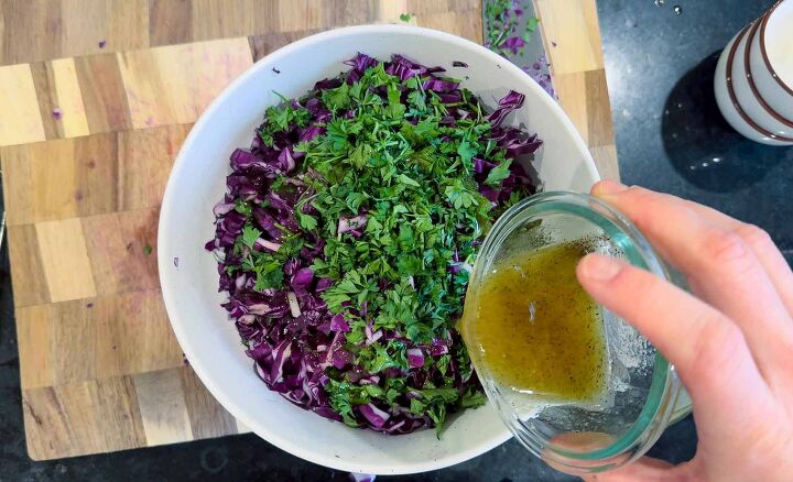 fresh easy turkish red cabbage salad recipe, pouring dressing over turkish red cabbage salad