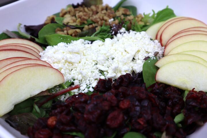 apple spinach salad with cranberries and feta, apple cranberry feta spinach and walnuts in a large bowl